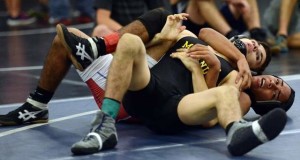 Forest Hill's Pablo Asenjo (bottom) grapples with Ryan Hudson of Merritt Island at Bayside High School. Hudson advanced to the state semifinals. / Craig Bailey/FLORIDA TODAY file
